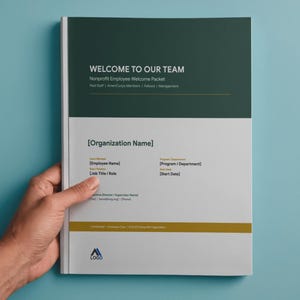 May include: A welcome pack for new employees, with the text "WELCOME TO OUR TEAM" in white on a dark green and white cover. The pack includes space for the employee's name, job title, and start date. The pack is held by a hand.