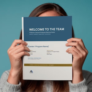 May include: A welcome pack titled "WELCOME TO THE TEAM" for childcare and daycare employees. The cover is blue and white with text that includes "Childcare & Daycare Employee Welcome Packet". The pack is held in front of a person.