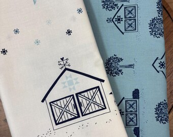 May include: Two folded pieces of fabric. One is white with a dark blue barn graphic, a weather vane, and small star patterns. The other is light blue with a repeating pattern of dark blue trees and barn structures with cross-hatch doors.