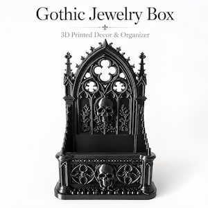 Könnte beinhalten: Eine schwarze, 3D-gedruckte Schmuckschatulle mit gotischen Architekturelementen, Spitzbögen, Vierpassmustern und zwei Totenkopfmotiven. Der Text "Gothic Jewelry Box" und "3D Printed Decor & Organizer" ist über dem Objekt abgedruckt.