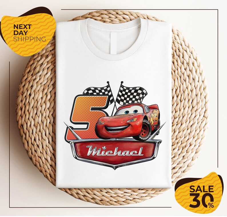 A white t-shirt with a graphic design featuring a red car and checkered flags, along with the text "Michael" and "Sale 30%".