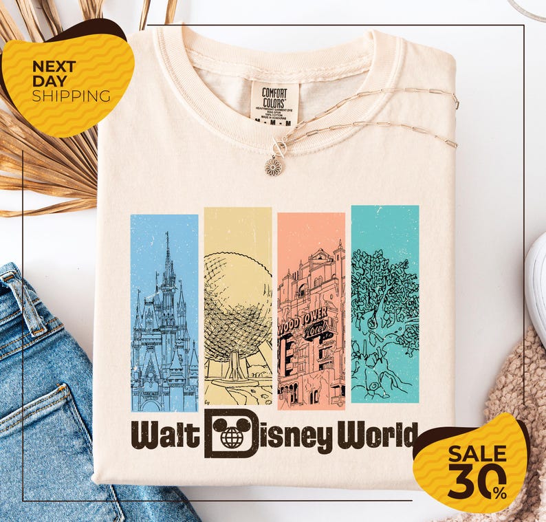 A white t-shirt with a graphic design featuring illustrations of various Disney landmarks, including the Eiffel Tower, the castle, and the roller coaster, along with the text "Walt Disney World". The t-shirt is displayed on a white background, and there are yellow and black sale signs indicating a 30% discount.