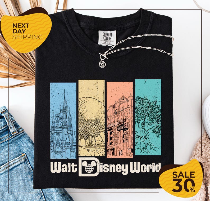 a black t-shirt with a graphic design depicting various landmarks and attractions from Walt Disney World, including the Eiffel Tower, the Disney castle, and the Wood Tower. The t-shirt is displayed on a white background, and there are two yellow sale signs indicating a 30% discount on the item.