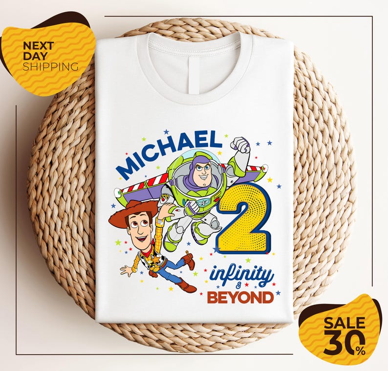A white t-shirt with a graphic design featuring characters from the Toy Story franchise, specifically Buzz Lightyear and Woody, along with the text "Michael 2 infinity beyond". The t-shirt is displayed on a woven placemat, and there are yellow price tags with text indicating a sale of 30% off.