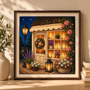 May include: A framed diamond painting depicting a cozy cottage exterior at night. The scene features a glowing street lamp, a door with a floral wreath, and windows filled with lit candles and potted plants. Pink flowers climb the wall.