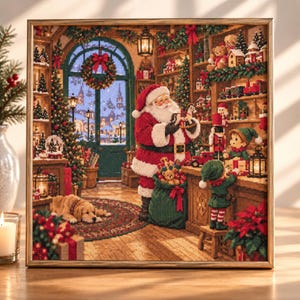 May include: A framed cross-stitch embroidery depicting a festive workshop scene with Santa Claus holding a toy, an elf standing at a wooden counter, a golden retriever lying on a rug, and shelves filled with various Christmas toys and decorations.