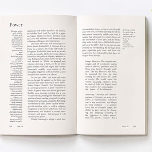 May include: An open book with white pages and black printed text. The left page is titled Power and contains Law 48, page 194. The right page continues the text, ending on page 195. The layout features columns of text with clear margins.