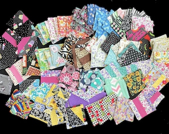 May include: A collection of colorful fabric squares with various patterns, including polka dots, stripes, and floral designs. The squares are arranged in a random pattern and are all approximately the same size.