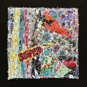 May include: A square fabric collage featuring vertical strips of floral, polka dot, and patterned textiles in yellow, blue, red, and green. The piece includes a bright orange bird, red cherries, and a yellow speech bubble with the word SUPER in red.