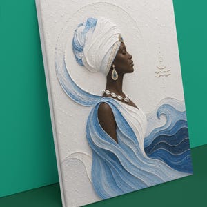 May include: A textured wall art piece depicting a profile of a person with dark skin wearing a white and blue headwrap, a shell necklace, and blue teardrop earrings. The artwork features raised white and blue swirling patterns resembling ocean waves.