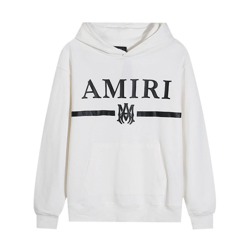 May include: White hoodie with a front pocket and a hood. The word "AMIRI" is printed in black across the chest, above a black horizontal stripe and a decorative emblem.