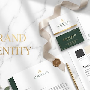 May include: A brand identity mockup featuring business cards, stationery, and color swatches. The design includes gold accents, a ribbon, and the text "BRAND IDENTITY". The business cards have the text "AURUM & CO."