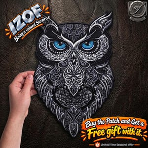 May include: An embroidered owl patch featuring intricate silver and grey filigree patterns on a black background with striking bright blue eyes. The patch includes the text IZOF Bring a valued surprise and Buy the Patch and Get a Free gift with it.