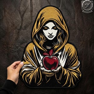 Può includere: Una toppa ricamata raffigurante una figura incappucciata dalla pelle pallida e i capelli scuri, che indossa una veste dorata e nera. La figura tiene tra le mani una mela rossa brillante con foglie verdi. Il design utilizza fili ad alto contrasto.