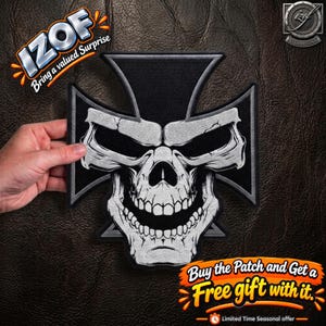 May include: A black and white embroidered iron-on patch featuring a stylized skull centered on an iron cross shape. The skull design includes detailed shading, a wide grin, and prominent eye sockets, with a black border surrounding the cross.