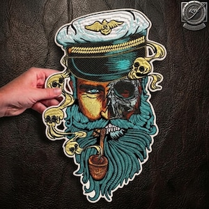 May include: An embroidered patch featuring a sea captain with a teal beard, a pipe, and a skull-themed face. The captain wears a white naval hat with a gold emblem. Swirling yellow smoke patterns with small skulls surround the central figure.