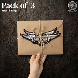 May include: A brown paper package tied with twine, featuring a Harley-Davidson patch with a winged emblem. The text "Pack of 3" and "Size: 12" Large" are visible. The patch is brown, black, and silver.