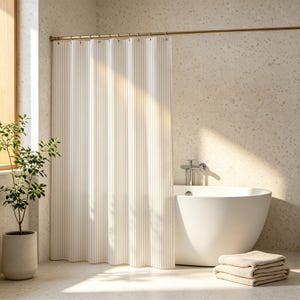 May include: A shower curtain featuring a vertical pinstripe pattern in off-white and light beige. The curtain hangs from a metallic rod with circular rings, displaying a pleated drape that extends from the ceiling to the floor in a bathroom.