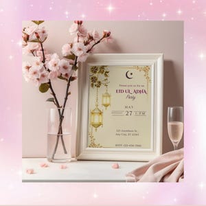 May include: A framed invitation for an Eid Ul Adha party, with a crescent moon and lantern design. The invitation is displayed with a vase of pink flowers, a champagne flute, and a pink cloth. The text reads "Eid Ul Adha Party, May 27, 1 PM."