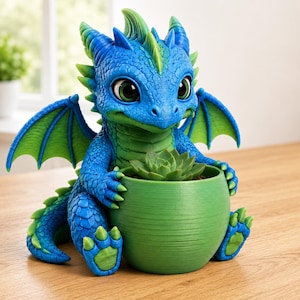 May include: A blue and green dragon figurine holding a round green planter containing a small succulent plant. The dragon has large dark eyes, textured scales, and small wings. The planter is smooth with visible horizontal lines on its surface.