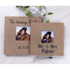 May include: Two brown burlap photo albums with black text. The first album says "The Jennings Family est. 2020" and the second album says "Mr. & Mrs. Palmer".