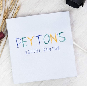 May include: White background with blue and yellow text that reads "PEYTON'S SCHOOL PHOTOS"