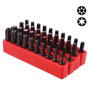 May include: A collection of dark brown screwdriver bits, including hex and star shapes, stored in a red plastic organiser. The bits are arranged neatly. Two star-shaped symbols are in the upper right corner.