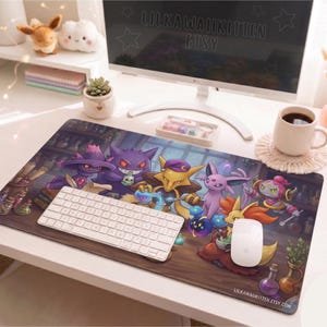 May include: A rectangular mousepad featuring a colorful illustration of various cartoon characters. The design includes a white keyboard and mouse, a coffee mug, and a computer monitor. The mousepad has the text "LILKAWAIIKITTEN ETSY" and "LILKAWAIIKITTEN.ETSY.COM".