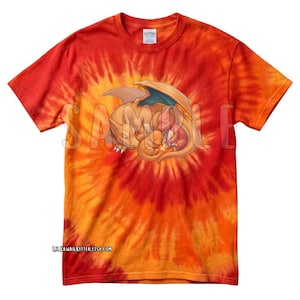 May include: A tie-dye t-shirt in shades of orange and red, featuring a graphic of a sleeping dragon family. The design includes a large dragon with smaller dragons nestled together. The text "LILKAWAIIKITTEN.ETSY.COM" is printed at the bottom.