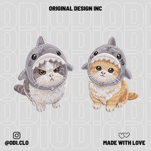 May include: Embroidered patches of two cats in shark hats. One is grey and white, the other orange and white. The text "ORIGINAL DESIGN INC" is at the top, and "@ODI.CLO" and "MADE WITH LOVE" are at the bottom.