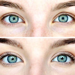 May include: A split image shows two sets of blue eyes with dark eyebrows. The top image shows eyes without makeup, while the bottom image shows eyes with mascara and longer eyelashes, enhancing the eye's appearance. The skin tone is fair.