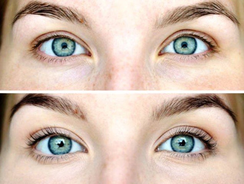 May include: A split image shows two sets of blue eyes with dark eyebrows. The top image shows eyes without makeup, while the bottom image shows eyes with mascara and longer eyelashes, enhancing the eye's appearance. The skin tone is fair.