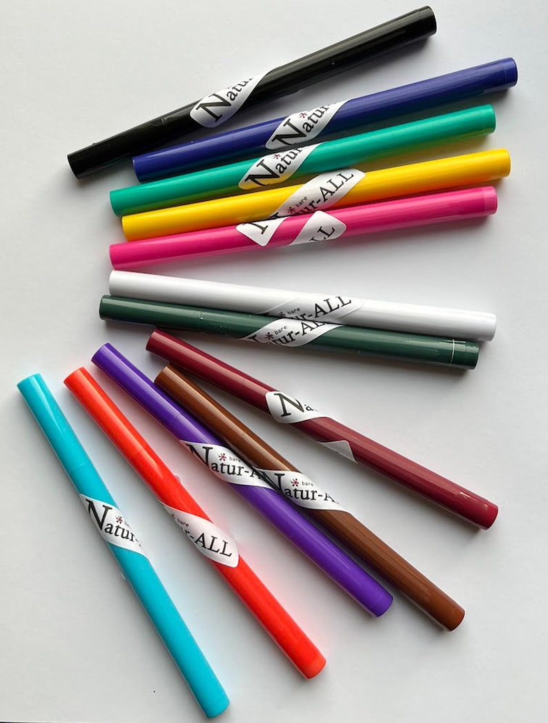A collection of colorful markers or pens with various colors and labels, including "All" and "Natural".