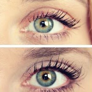 May include: Close-up of two eyes with long, dark eyelashes. The irises are a mix of green and blue, with a dark pupil. The skin around the eyes is light-toned, with a hint of pink eyeshadow. The eyebrows are lightly shaped.
