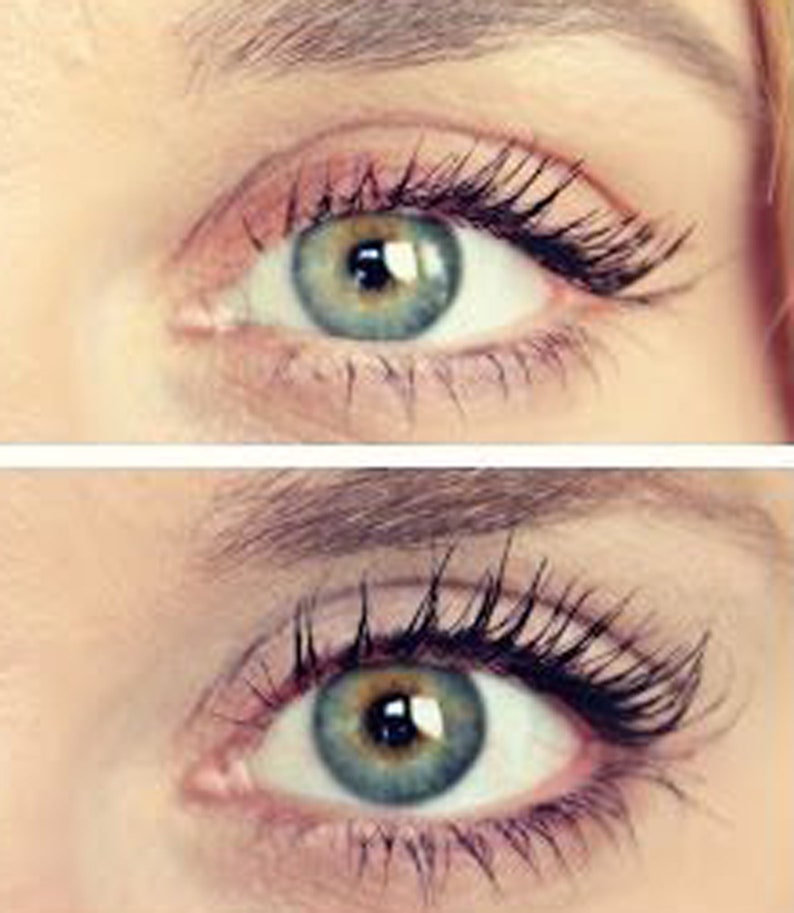 May include: Close-up of two eyes with long, dark eyelashes. The irises are a mix of green and blue, with a dark pupil. The skin around the eyes is light-toned, with a hint of pink eyeshadow. The eyebrows are lightly shaped.