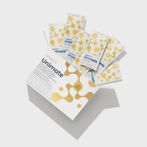 May include: A white box and several individual packets of Unicity Unimate Lemon Ginger flavoured drink mix. The box and packets feature a gold and white abstract design and the Unicity Unimate logo.