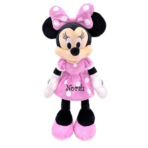 May include: A plush Minnie Mouse doll in a pink dress with white polka dots and a matching bow. The doll has black ears, a tan muzzle, and the name "Norah" embroidered on the dress. The doll is approximately 16 inches tall.