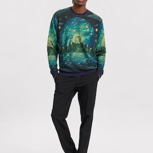 May include: A long-sleeve crewneck sweatshirt featuring a vibrant, all-over graphic print of a swirling night sky, glowing moon, and forest landscape in shades of teal, green, and yellow, paired with solid black trousers and white sneakers.
