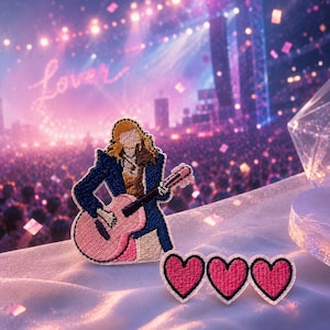 May include: An embroidered patch featuring a figure with long blonde hair wearing a dark blue jacket and playing a pink acoustic guitar, accompanied by three smaller heart-shaped embroidered patches with pink centers and black borders.