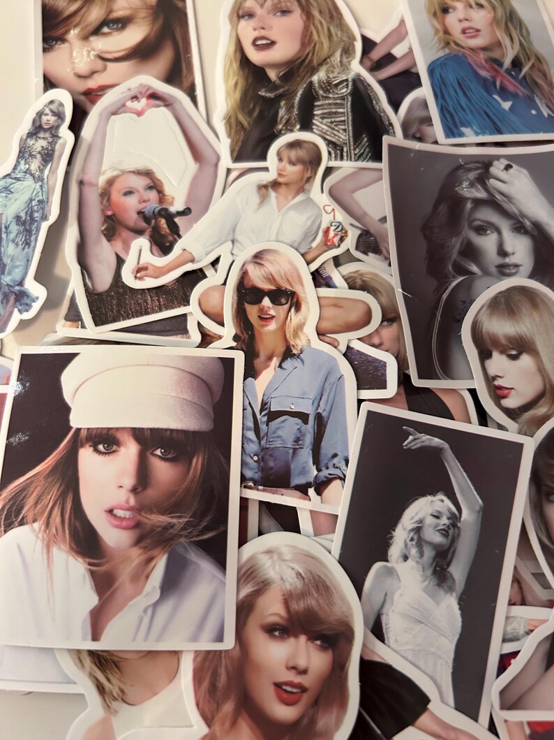 May include: A collection of assorted stickers featuring various photographic portraits and performance images of Taylor Swift, showcasing different outfits, hairstyles, and expressions in both color and black and white printed formats.