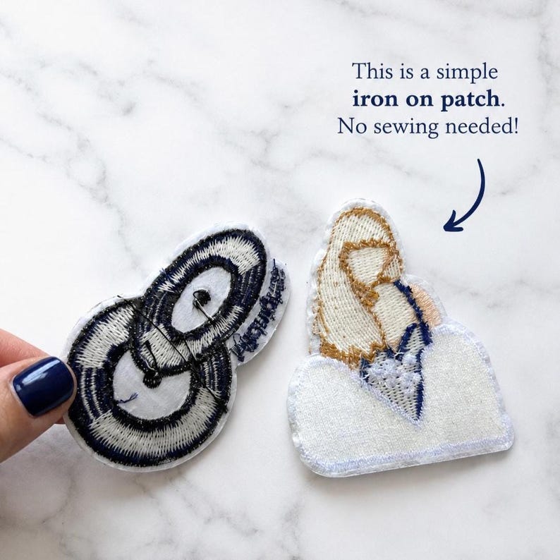 May include: Two embroidered patches. One patch features a black and white circular design. The other patch depicts a tan and white figure on a white base. Text reads: This is a simple iron on patch. No sewing needed!