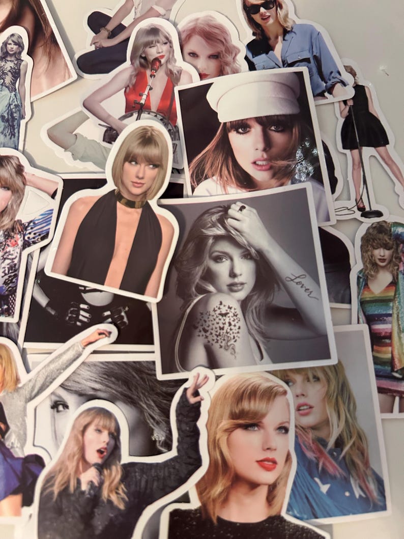 May include: A collection of die-cut stickers featuring various photographic portraits of Taylor Swift in different outfits, hairstyles, and poses, including one black and white image with the word Lover written on the arm and a butterfly tattoo.
