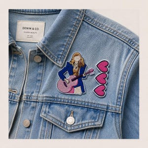 May include: A light blue denim jacket with a white label reading DENIM & CO. CLASSIC QUALITY EST 1998. Two embroidered patches are attached: one depicts a person with long hair in a blue blazer playing a pink guitar, and the other shows three pink hearts.