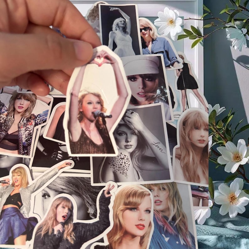 May include: A collection of die-cut vinyl stickers featuring various photographic portraits and performance images of Taylor Swift, including shots of her singing, posing, and wearing different outfits, with one sticker showing a heart hand gesture.
