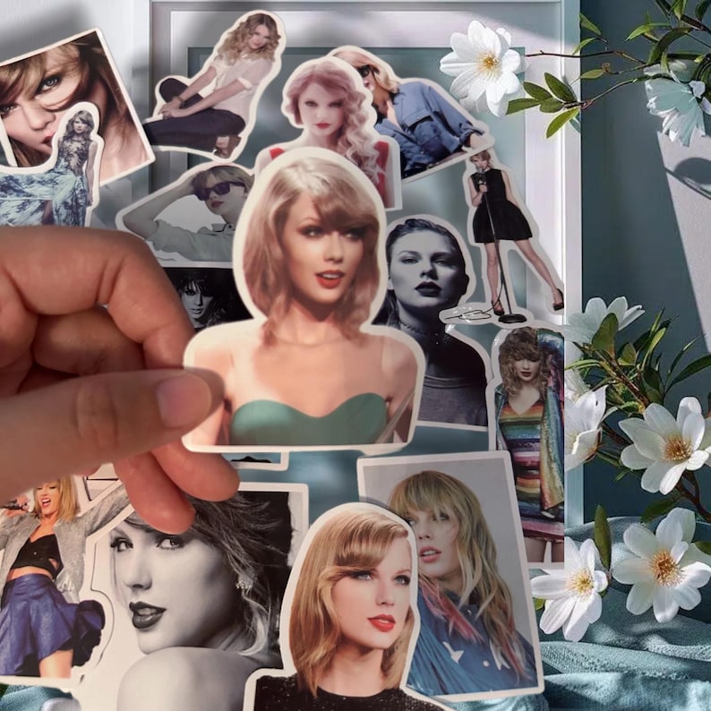 May include: A collection of die-cut vinyl stickers featuring various photographic portraits and full-body images of Taylor Swift in different outfits, hairstyles, and poses, including black-and-white and color prints, displayed on a white frame.