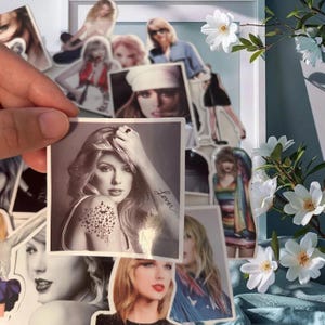 May include: A square sticker featuring a black and white portrait of a person with long hair, a butterfly tattoo on the shoulder, and the word Lover written in cursive on the forearm. The sticker is held against a collection of similar stickers.