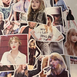 May include: A collection of die-cut stickers featuring various photographic portraits and performance images of Taylor Swift. The stickers display diverse outfits, hairstyles, and expressions, including one sticker with the text NOT A LOT GOING ON AT THE MOMENT.