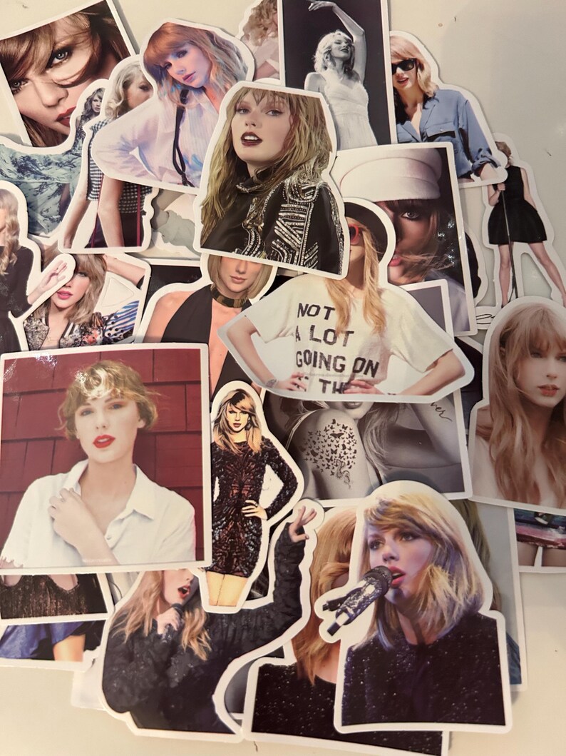 May include: A collection of die-cut stickers featuring various photographic portraits and performance images of Taylor Swift. The stickers display diverse outfits, hairstyles, and expressions, including one sticker with the text NOT A LOT GOING ON AT THE MOMENT.