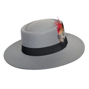 May include: A grey fedora hat with a black band and a decorative feather. The hat has a wide brim and a rounded crown. The feather is red, black, and white. A stylish accessory for any occasion.