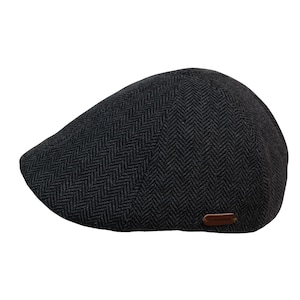 May include: A dark grey herringbone pattern flat cap with a small, brown leather tag. The cap features a rounded crown and a short, stiff peak. The fabric has a textured appearance. The cap is suitable for all genders.